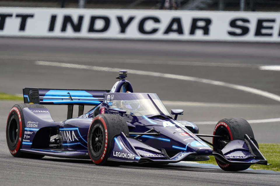 FILE - In this May 15, 2021, file photo, Jimmie Johnson drives through a turn during the IndyCar auto race at Indianapolis Motor Speedway in Indianapolis. Johnson is hopeful of testing in August at Homestead-Miami Speedway as part of a path toward running in the Indianapolis 500 in 2022. The seven-time NASCAR champion jumped this season to IndyCar and has competed in seven races for team owner Chip Ganassi.(AP Photo/Michael Conroy, File)