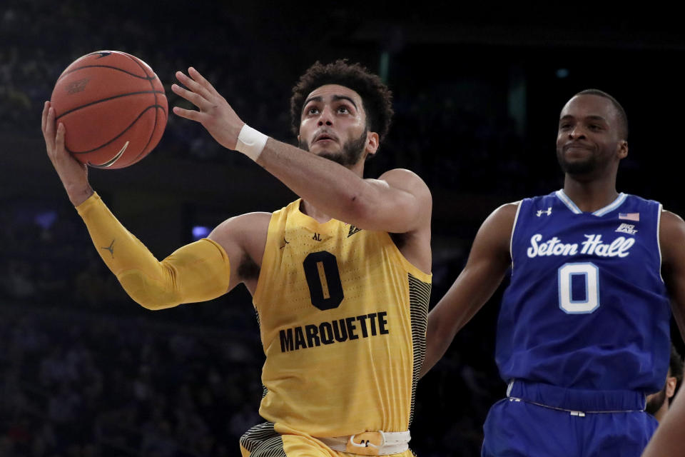 Marquette guard Markus Howard (0) goes up for a shot against Seton Hall guard Quincy McKnight (0) during the first half of an NCAA college basketball semifinal game in the Big East men's tournament, Friday, March 15, 2019, in New York. (AP Photo/Julio Cortez)