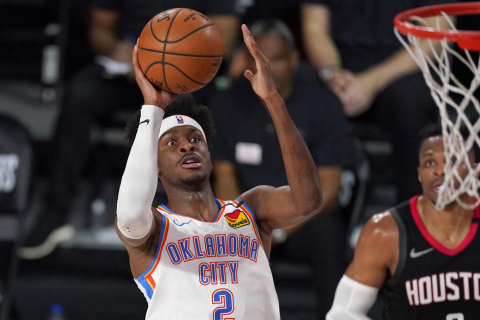 Oklahoma City Thunder's Shai Gilgeous-Alexander (2) goes for a shot as Houston Rockets' Russell Westbrook, rear, looks on. (AP Photo/Mark J. Terrill)