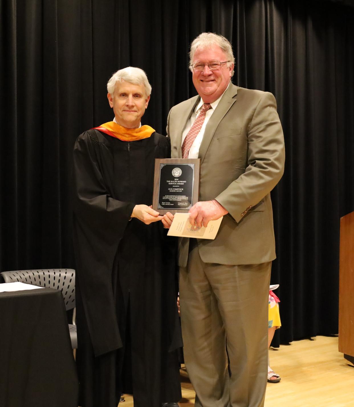 Ohio State Marion Dean and Director Gregory S. Rose, right, presents Gus Comstock with the school's Ralph Howard Service Award for his efforts to connect businesses and community leaders with campus initiatives.