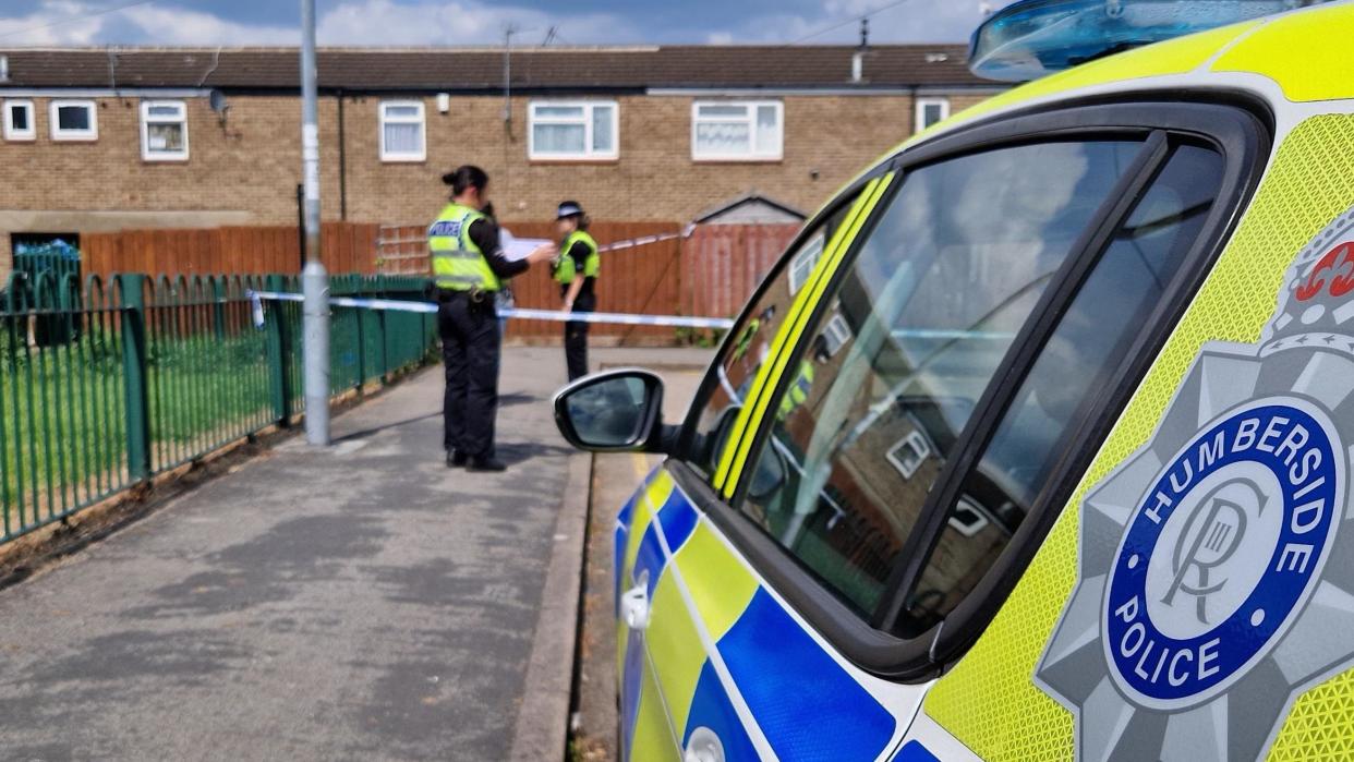 Two police officers at a cordon in Arundel Close, Hull