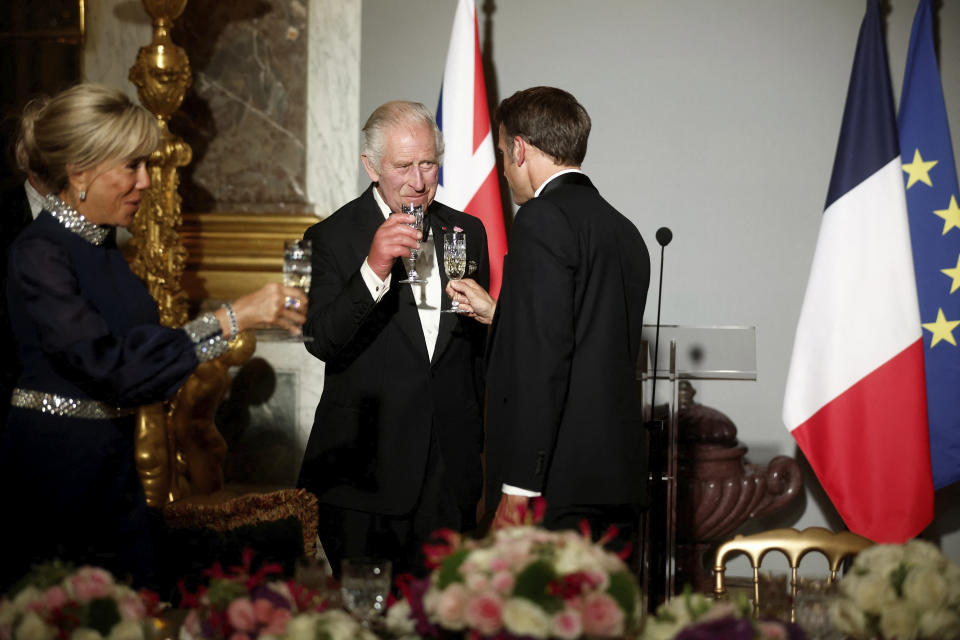 French President Emmanuel Macron, right, Britain's King Charles and Brigitte Macron toast during a state dinner in the Hall of Mirrors at the Chateau de Versailles in Versailles, west of Paris, Wednesday, Sept. 20, 2023. President Emmanuel Macron and King Charles III held talks in Paris on Wednesday at the start of a long-awaited three-day state visit meant to highlight the friendship between France and the U.K. (Benoit Tessier/Pool via AP)