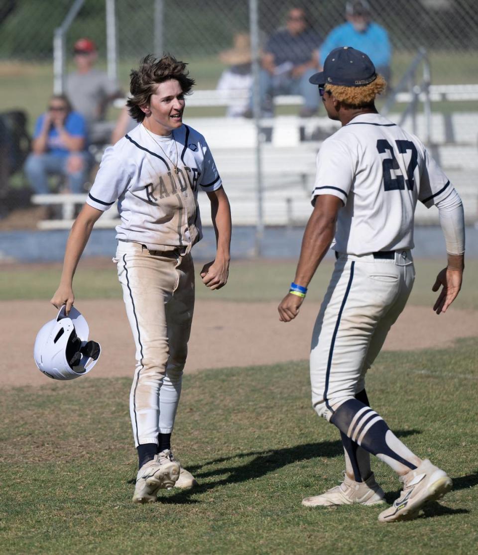 Central Catholic’s Chase Perino comes off the field and is greeted by teammate Joel Roberts after scoring from second during the Division III Sac-Joaquin Section playoff game with Christian Brothers at Central Catholic High School in Modesto, Calif., Wednesday, May 17, 2023.