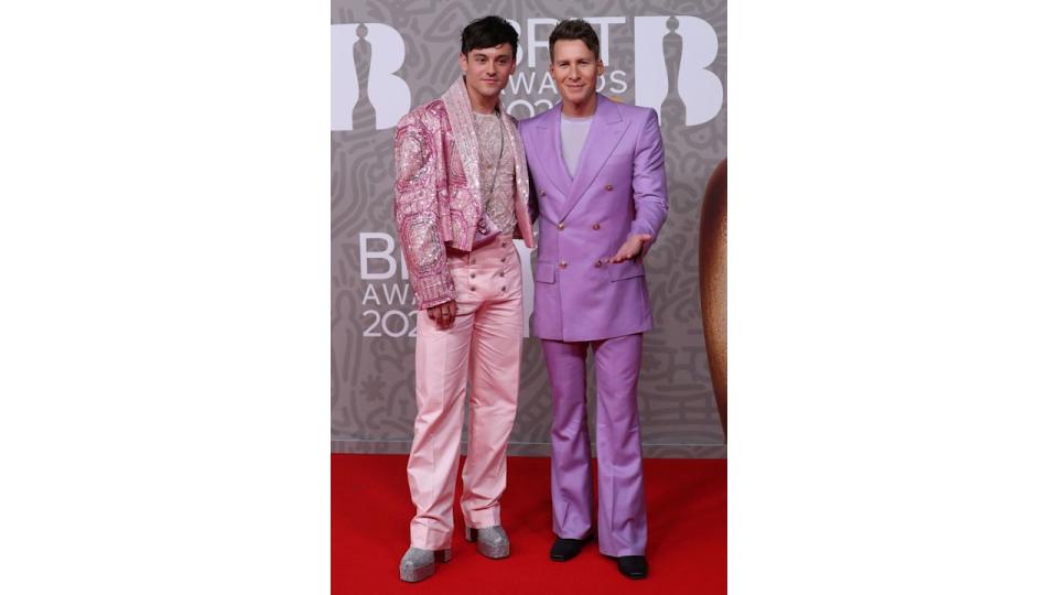 Tom Daley in a sparkly pink suit and Dustin Lance Black in a purple suit