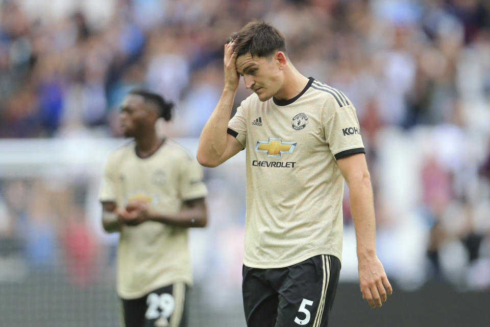 Manchester United's Harry Maguire touches his forehead as he leaves at the end of the English Premier League soccer match between West Ham and Manchester United at London stadium in London, Sunday, Sept. 22, 2019. West Ham beat Manchester United 2-0. (AP Photo/Leila Coker)