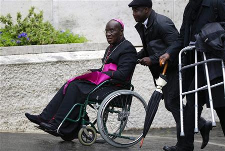 Bishop Jean-Pierre Kutwa of Ivory Coast arrives on a wheelchair to attend a special consistory for the family led by Pope Francis in the Paul VI's hall at the Vatican February 20, 2014. REUTERS/Max Rossi