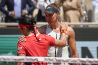 Tunisia's Ons Jabeur, left, congratulates Brazil's Beatriz Haddad Maia with winning the quarterfinal match of the French Open tennis tournament in three sets, 3-6, 7-6 (7-5), 6-1, at the Roland Garros stadium in Paris, Wednesday, June 7, 2023. Haddad Maia is the first Brazilian woman to reach a Grand Slam semifinal since Maria Bueno at the 1968 U.S. Open. (AP Photo/Christophe Ena)
