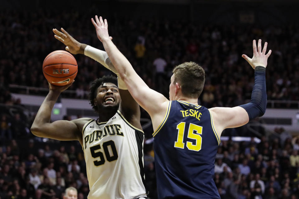 Purdue forward Trevion Williams (50) shoots over Michigan center Jon Teske (15) during the second half of an NCAA college basketball game in West Lafayette, Ind., Saturday, Feb. 22, 2020. (AP Photo/Michael Conroy)