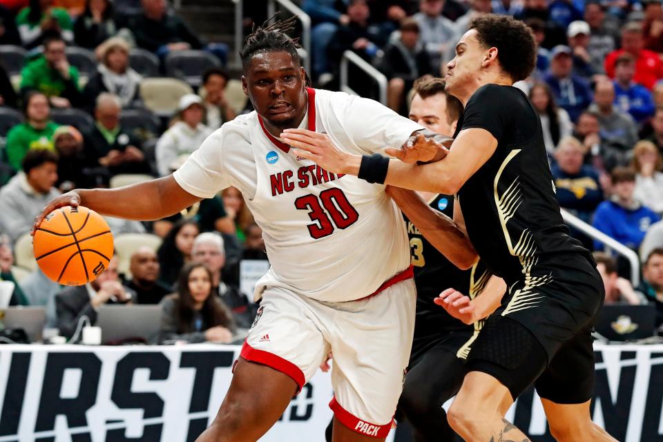 North Carolina State forward DJ Burns Jr. (30) drives to the basket against Oakland forward Chris Conway (2) during the men's NCAA Tournament at PPG Paints Arena.