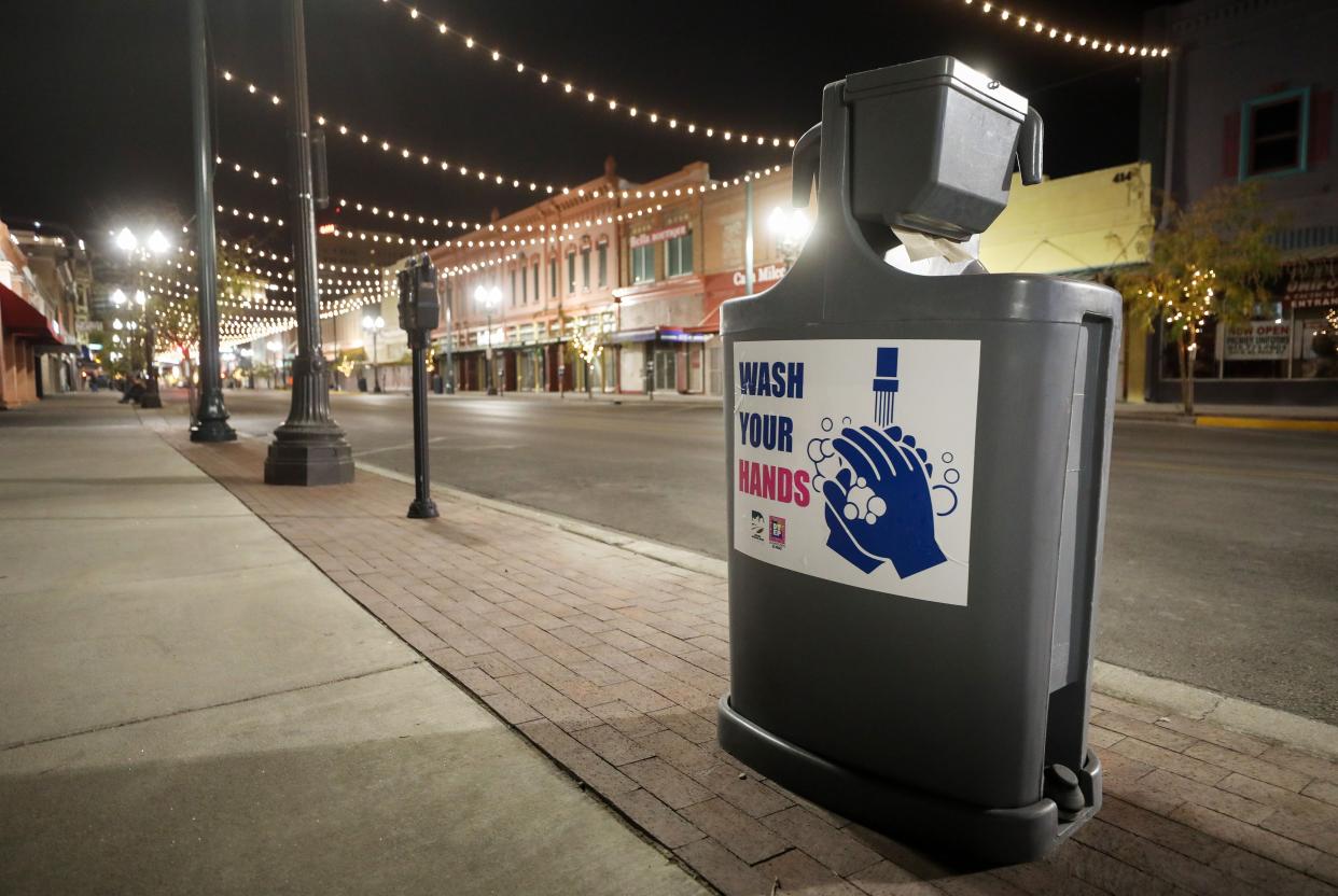 A hand washing station is posted on an empty El Paso Street downtown amid a surge of COVID-19 cases on Nov. 12, 2020 in El Paso, Texas. Texas eclipsed one million COVID-19 cases on November 11 with El Paso holding the most cases statewide.