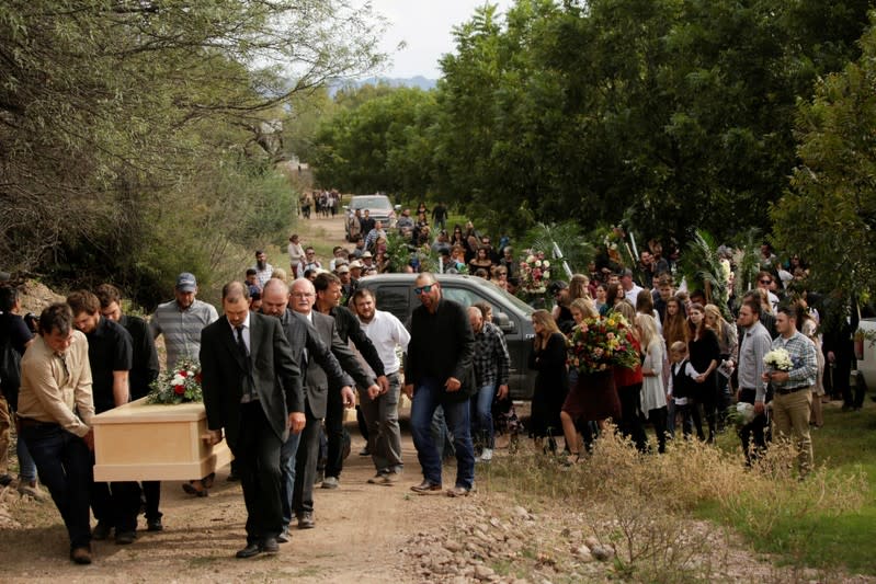 Relatives carry the remains of Dawna Ray Langford and her sons Trevor, Rogan, who were killed by unknown assailants, to be buried at the cemetery in La Mora