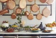 <p>In her Hollywood Hills kitchen, <a href="https://www.veranda.com/luxury-lifestyle/a27105011/ellen-pompeo-martyn-lawrence-bullard-hollywood-entertaining/" rel="nofollow noopener" target="_blank" data-ylk="slk:Ellen Pompeo" class="link ">Ellen Pompeo</a> used a collection of copperware (<a href="https://go.redirectingat.com?id=74968X1596630&url=https%3A%2F%2Fwww.williams-sonoma.com%2Fproducts%2Fmauviel-copper-12-piece-cookware-set-2015%2F%3Fpkey%3Dccookware-copper%257Ccopper-cookware-sets%26isx%3D0.0.1180&sref=https%3A%2F%2Fwww.veranda.com%2Fdecorating-ideas%2Fg30872412%2Fkitchen-decor-ideas%2F" rel="nofollow noopener" target="_blank" data-ylk="slk:Williams-Sonoma" class="link ">Williams-Sonoma</a>) as decoration and to mark the delicious buffet for an intimate dinner party hosted with friend and designer <a href="https://martynlawrencebullard.com/" rel="nofollow noopener" target="_blank" data-ylk="slk:Martyn Lawrence Bullard" class="link ">Martyn Lawrence Bullard</a>. The placement not only <a href="https://www.veranda.com/decorating-ideas/g30380924/wall-decor-ideas/" rel="nofollow noopener" target="_blank" data-ylk="slk:dresses up the walls" class="link ">dresses up the walls</a>, but also offers a clever way to store pots and pans in <a href="https://www.veranda.com/decorating-ideas/tips/g1312/apartment-decorating-ideas/" rel="nofollow noopener" target="_blank" data-ylk="slk:smaller cook spaces or apartments" class="link ">smaller cook spaces or apartments</a>. </p>