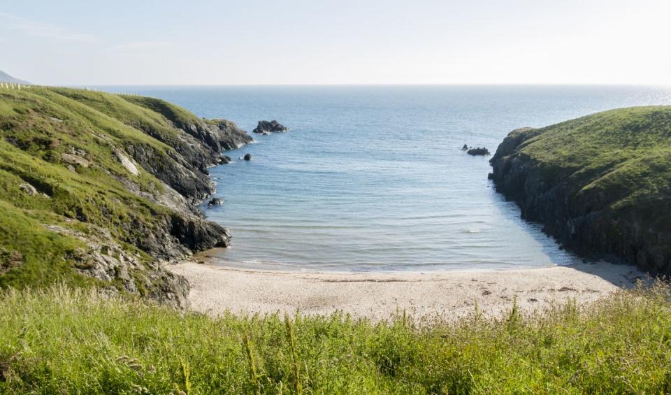 <p>One of the best beaches in North Wales, Porth Iago boasts clear, turquoise waters, making it a delightful spot for swimming. One of Wales' more 'secret' sands, it's a must-visit on the Llyn Peninsula. There's an ancient hill fort lookout that overlooks the beach and the rocks on its north side are great for fishing, with bass known to be caught here.</p><p><strong>Where to stay: </strong>A peaceful cottage around a 13-minute drive away in Anelog, this cute rural rental is great for couples, families or a group of friends. It sleeps five and there's plenty of character and countryside views. </p><p><a class="link " href="https://www.sykescottages.co.uk/cottage/North-Wales-Snowdonia-Anelog/Ty-Hen-954304.html" rel="nofollow noopener" target="_blank" data-ylk="slk:SEE INSIDE;elm:context_link;itc:0;sec:content-canvas">SEE INSIDE</a></p>