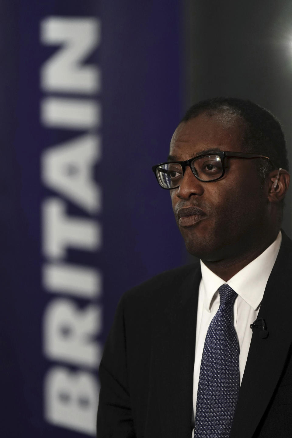 Britain's Chancellor of the Exchequer Kwasi Kwarteng speaks to the media ahead of the Conservative Party annual conference at the International Convention Centre in Birmingham, England, Monday, Oct. 3, 2022. The British government has dropped plans to cut income tax for top earners, part of a package of unfunded cuts that sparked turmoil on financial markets and sent the pound to record lows. (Aaron Chown/PA via AP)