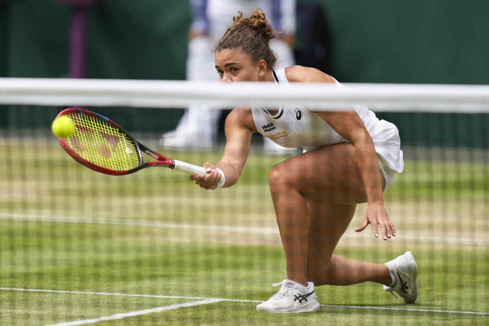 Jasmine Paolini of Italy plays a forehand return to Barbora Krejcikova of the Czech Republic during the women's singles final at the Wimbledon tennis championships in London, Saturday, July 13, 2024. (AP Photo/Kirsty Wigglesworth)