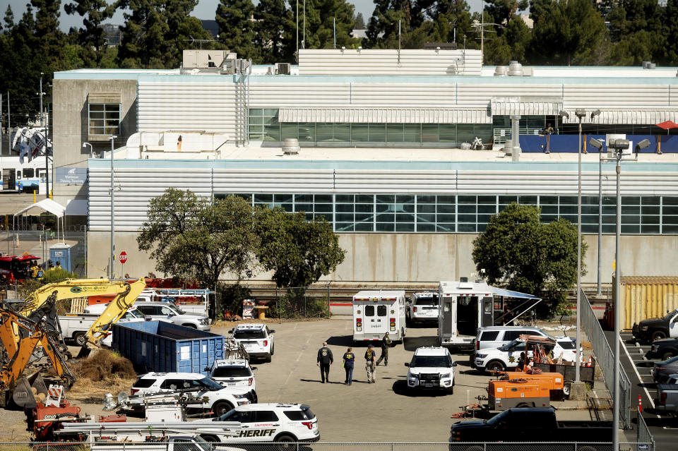 FILE - Law enforcement officers respond to the scene of a shooting at a Santa Clara Valley Transportation Authority (VTA) facility on May 26, 2021, in San Jose, Calif. One year after a problem employee shot and killed nine coworkers in a rampage at a light rail yard, the family of one of the victims filed a lawsuit, Thursday, May 26, 2022, alleging negligence and wrongful death by the Northern California transportation agency, the Santa Clara County Sheriff's Office and a private security firm by failing to address the gunman's history of violent threats and concerns raised by employees about him. (AP Photo/Noah Berger, File)