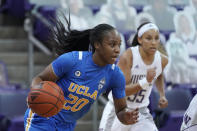UCLA guard Charisma Osborne (20) drives against Washington during the second half of an NCAA college basketball game, Sunday, Feb. 7, 2021, in Seattle. (AP Photo/Ted S. Warren)
