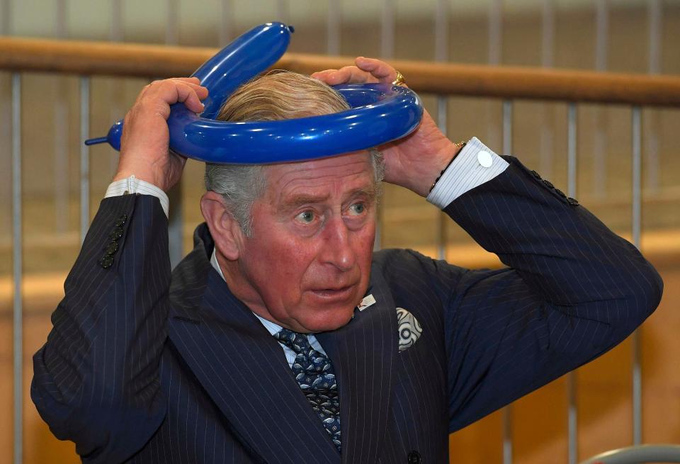 Prince Charles wears a balloon hat
