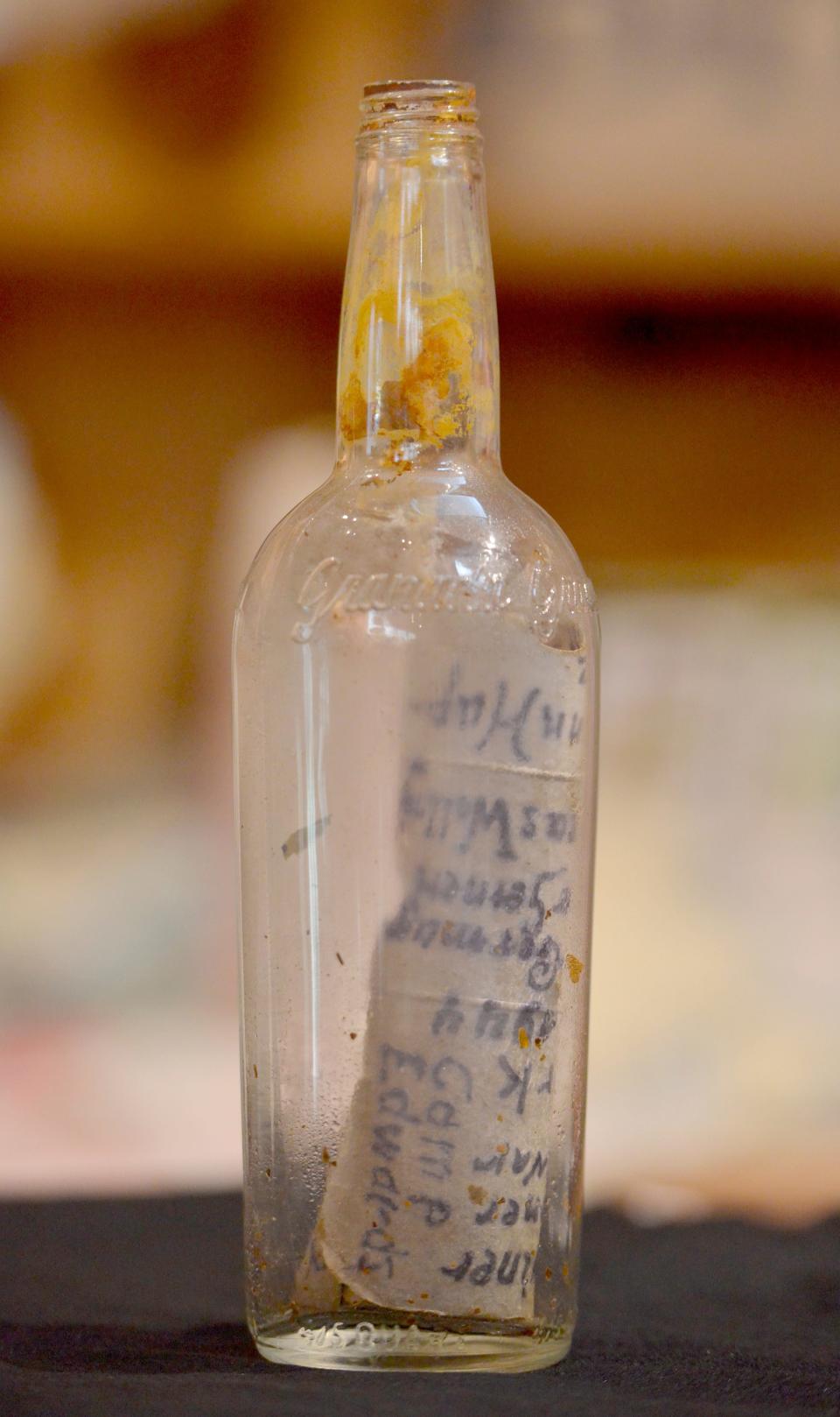 The Historical Society of Santuit & Cotuit has received this bottle containing notes with German names and dated in 1944. It was brought in from a local landscaper who discovered it on a hillside in Cotuit last week.