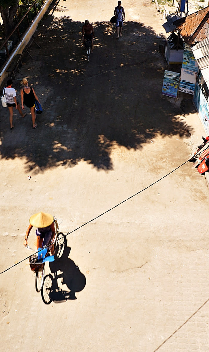 Time to ride: A tourist riding her bike during a sunny day. Don't forget your lotion to avoid getting burned when exploring Gili Trawangan.