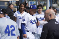 Los Angeles Dodgers manager Dave Roberts, center, introduces Ayo Robinson, rear left, the granddaughter of baseball legend Jackie Robinson, as Dodgers and Washington Nationals team members join in a celebration for Jackie Robinson Day before a baseball game at Dodgers Stadium in Los Angeles on Monday, April 15, 2024. (AP Photo/Damian Dovarganes)