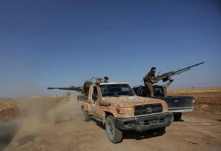 Rebel fighters in Marea city shoot a weapon towards Syria Democratic Forces (SDF) controlled Tell Rifaat town, northern Aleppo province, Syria October 21, 2016. REUTERS/Khalil Ashawi