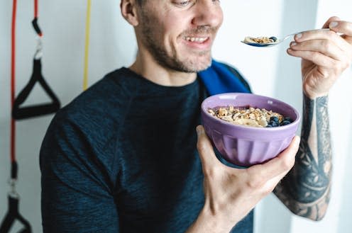 <span class="caption">Porridge was one of the carbs Mark Taylor, 2023's "Mr Universe", included in his diet.</span> <span class="attribution"><a class="link " href="https://www.shutterstock.com/image-photo/happy-caucasian-man-eating-muesli-bowl-2221418437" rel="nofollow noopener" target="_blank" data-ylk="slk:Ripio/ Shutterstock;elm:context_link;itc:0;sec:content-canvas">Ripio/ Shutterstock</a></span>