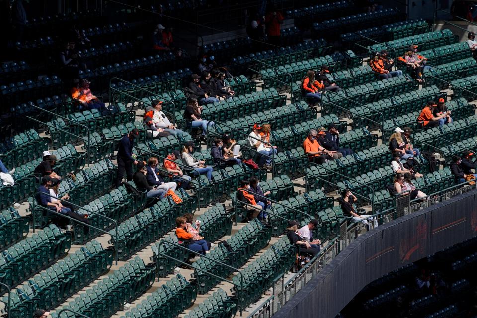 Fans sit distanced at Oracle Park in San Francisco before an opening day game between the Giants and the Colorado Rockies on April 9, 2021.