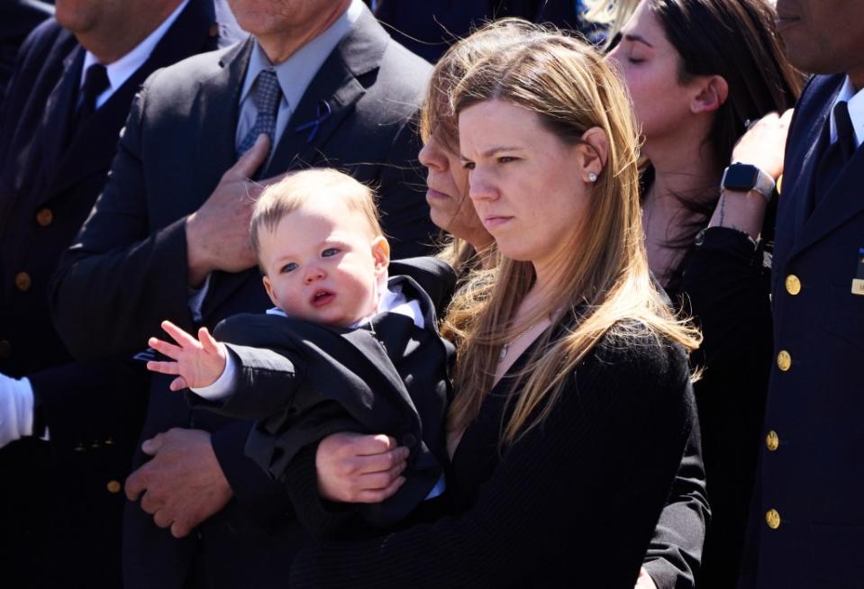 NYPD Detective Jonathan Diller’s son Ryan reached towards his father’s casket during the funeral on March 30, 2024. James Keivom