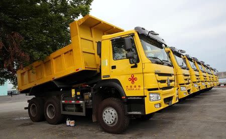 A row of dump trucks donated by China, that will aid in the rehabilitation of the war-torn Marawi city, is seen in the port of Iligan city, southern Philippines October 19, 2017. REUTERS/Romeo Ranoco