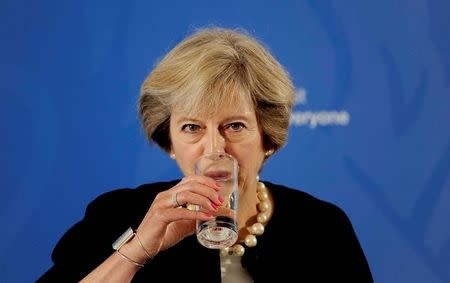 Prime Minister Theresa May takes a drink as she delivers a speech at the British Academy in London, where she said that a new wave of grammar schools will end "selection by house price" and give every child the chance to go to a good school, in Britain September 9, 2016. REUTERS/Nick Ansell/Pool