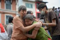 A Nepalese man and woman hold each other in Kathmandu's Durbar Square