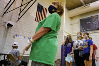 Students and parents wear mask as they wait to receive a second dose of the Pfizer COVID-19 vaccine during a vaccination clinic hosted by Jewel Osco at London Middle School in Wheeling, Ill., Friday, June 11, 2021. After nearly 15 months of shutdowns, limited capacity and sheltering at home, the State of Illinois, including Chicago, fully reopened today. Businesses still can have their own rules for capacity, masks and social distancing. Masks are still required on public transportation and in airports, schools and hospitals. (AP Photo/Nam Y. Huh)