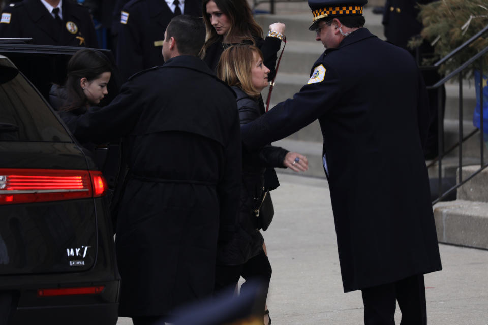 The wife of slain Chicago police Cmdr. Paul Bauer, Erin, right, and the Bauer's 13-year-old daughter, Grace, left, arrive to Nativity of Our Lord Catholic Church in Chicago on Saturday, Feb. 17, 2017. Cmdr. Bauer was shot to death while confronting a suspect earlier in the week. (Abel Uribe/Chicago Tribune/TNS via Getty Images)