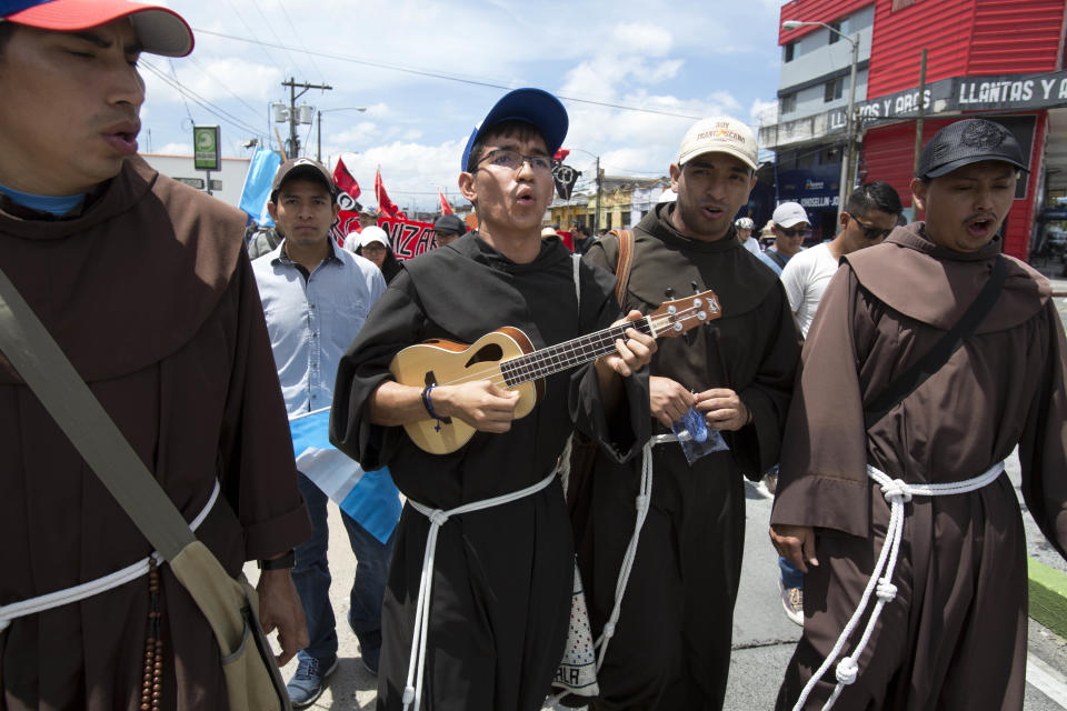 Seminarians sing as they march against Guatemalan President Jimmy Morales and in support of the fight against corruption in Guatemala City, Thursday, Sept. 20, 2018. Thousands marched to protest Morales' decision to end the work of a U.N. anti-corruption commission that has helped lead high-profile graft probes targeting dozens of powerful people, including one involving Morales. (AP Photo/Moises Castillo)