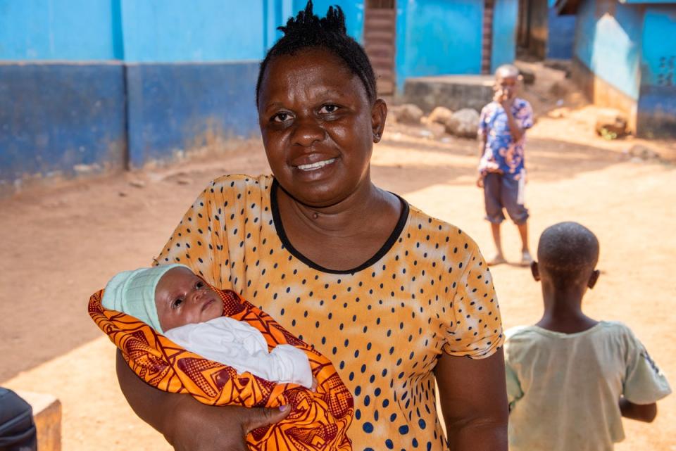 2YoungLives co-founder Mangenda Kamara holding a baby born to a teen mother, Freetown, Sierra Leone (Radhika Aligh/Evening Standard)