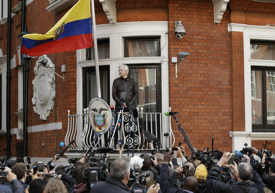 Watched by the media WikiLeaks founder Julian Assange looks out from the balcony of the Ecuadorian embassy prior to speaking, in London on May 19, 2017. (Matt Dunham/AP)