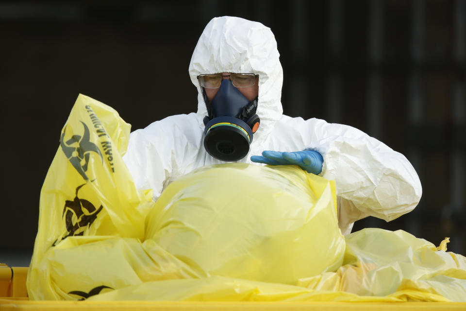 Clinical waste removal personnel are seen at St Basilâs Homes for the Aged in Fawkner, Melbourne, Friday, July 31, 2020.