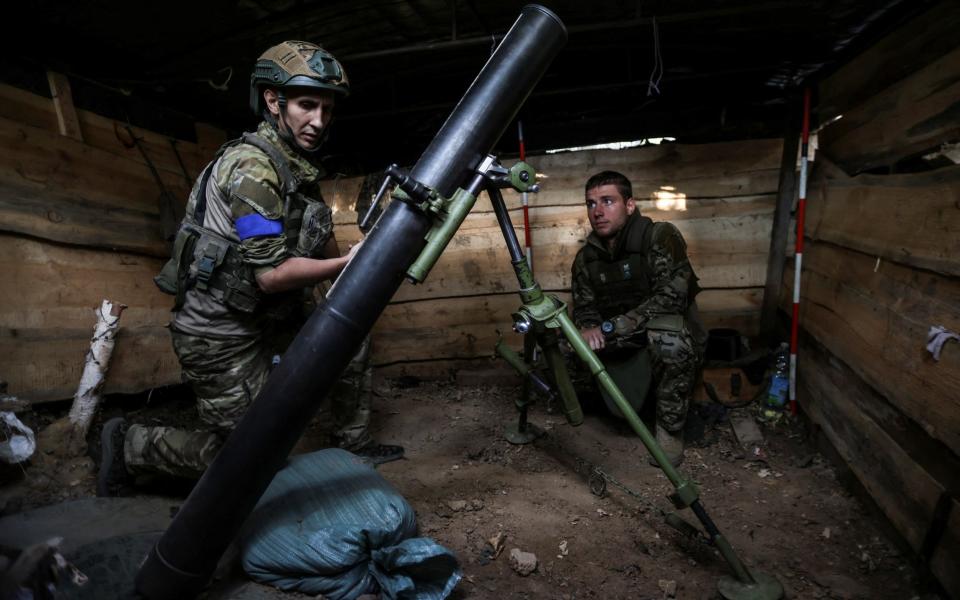 Ukrainian troops prepare a mortar at their position near a frontline in the Zaporizhzhia region