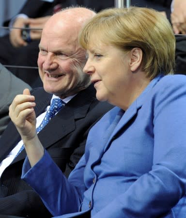 FILE PHOTO: German Chancellor Merkel chats with Piech, chairman of the supervisory board of Volkswagen during a visit at the plant of German carmaker in Wolfsburg