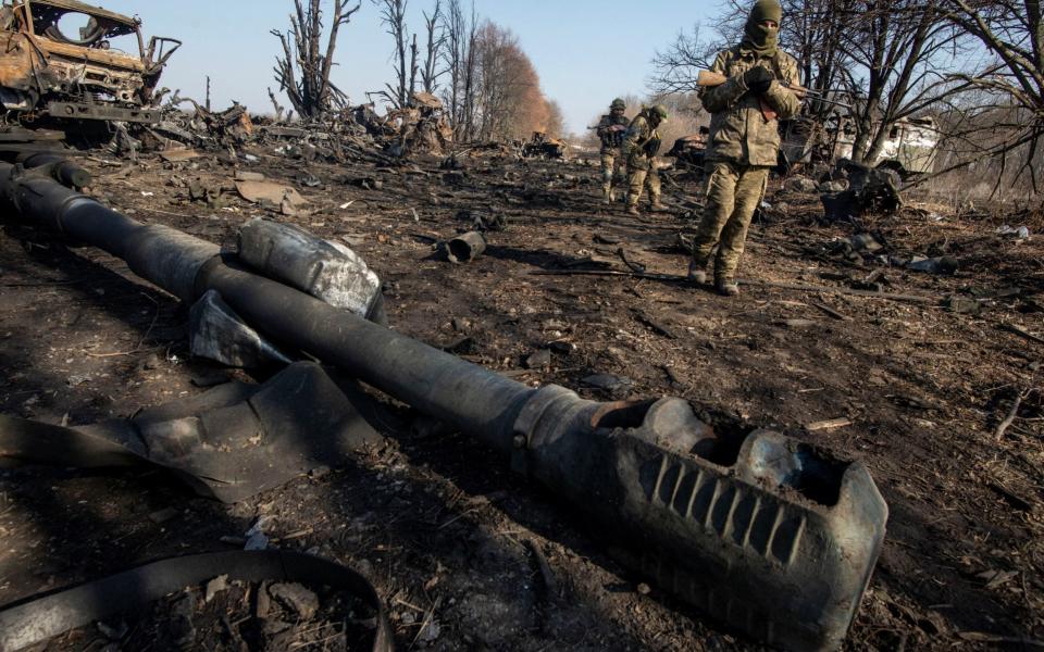 Ukrainian service members inspect destroyed Russian military vehicles, as Russia's attack on Ukraine continues, near the town of Trostianets, in the Sumy region - Ukrainian Ground Forces/Handout