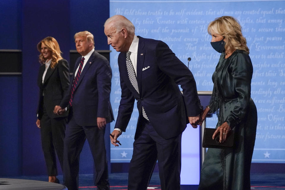 FILE - In this Sept. 29, 2020, photo, from left, first lady Melania Trump, President Donald Trump, Democratic presidential candidate former Vice President Joe Biden and Jill Biden during the first presidential debate at Case Western University and Cleveland Clinic, in Cleveland, Ohio. A book by Donald Trump's ex-chief of staff says Trump tested positive for COVID-19 three days before his first debate in September 2020. (AP Photo/Julio Cortez, File)