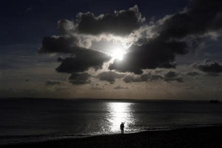 A man looks out to sea in Portsmouth November 25, 2013. The British shipbuilding industry has been through a turbulent time after defence contractor BAE Systems announced in November that it planned to lay off 1,775 ship workers across the UK. The cuts signal the end of more than 500 years of shipbuilding in Portsmouth on England's south coast. REUTERS/Stefan Wermuth