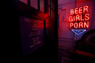 <p>A neon sign that reads ‘Beer, Girls, Porn’ is reflected in an old Police Box in God’s Own Junkyard gallery and cafe in London, Britain, May 13, 2017. (Photo: Russell Boyce/Reuters) </p>