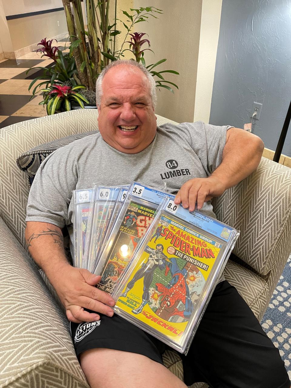SW-Florida ComicCon co-organizer David Hess poses with comics he bought at the August event.
