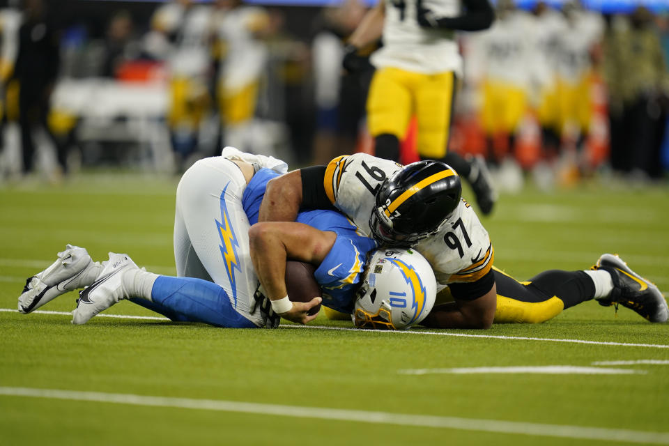 Pittsburgh Steelers defensive end Cameron Heyward tackles Los Angeles Chargers quarterback Justin Herbert during the second half of an NFL football game Sunday, Nov. 21, 2021, in Inglewood, Calif. (AP Photo/Ashley Landis)
