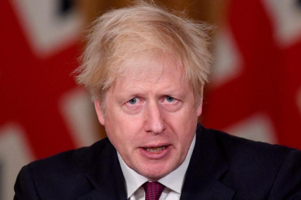 Britain’s Prime Minister Boris Johnson speaks during a news conference in response to the ongoing situation with the coronavirus disease (COVID-19) pandemic, inside 10 Downing Street on December 19, 2020 in London, England. (Photo by Toby Melville – WPA Pool / Getty Images)