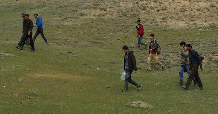 A group of Afghan migrants walk along a path on mountains after crossing the Turkey-Iran border near Erzurum, eastern Turkey, April 12, 2018. Picture taken April 12, 2018. REUTERS/Umit Bektas