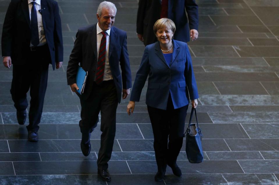 German Chancellor and leader of the Christian Democratic Union party (CDU) Angela Merkel arrives next to party fellow Stanislaw Tillich for preliminary coalition talks between Germany's conservative (CDU/CSU) parties and the Social Democratic Party (SPD) at the Parliamentary Society in Berlin October 14, 2013. Merkel is likely to pick a new coalition partner this week before moving on to detailed negotiations that could produce a new German government within about two months.REUTERS/Tobias Schwarz (GERMANY - Tags: POLITICS)