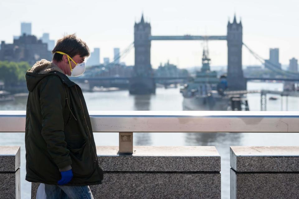 A man wearing a mask on London Bridge (PA)